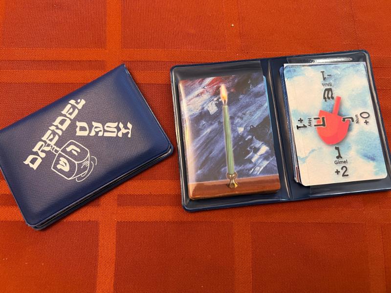 The wallet package of the game, closed and open with the cards visible inside.