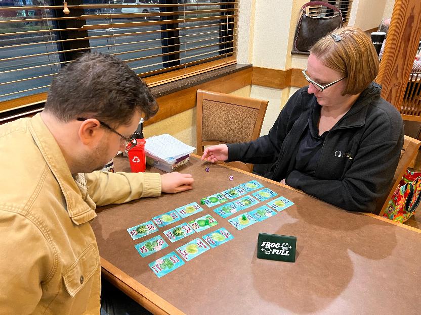 Two people play Frog Pull.